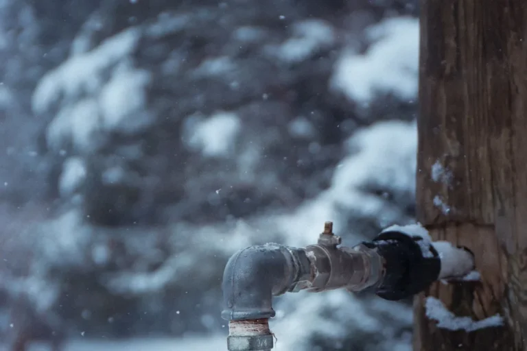 Outdoor water pipe and spigot in freezing winter conditions, at risk of a frozen or burst line