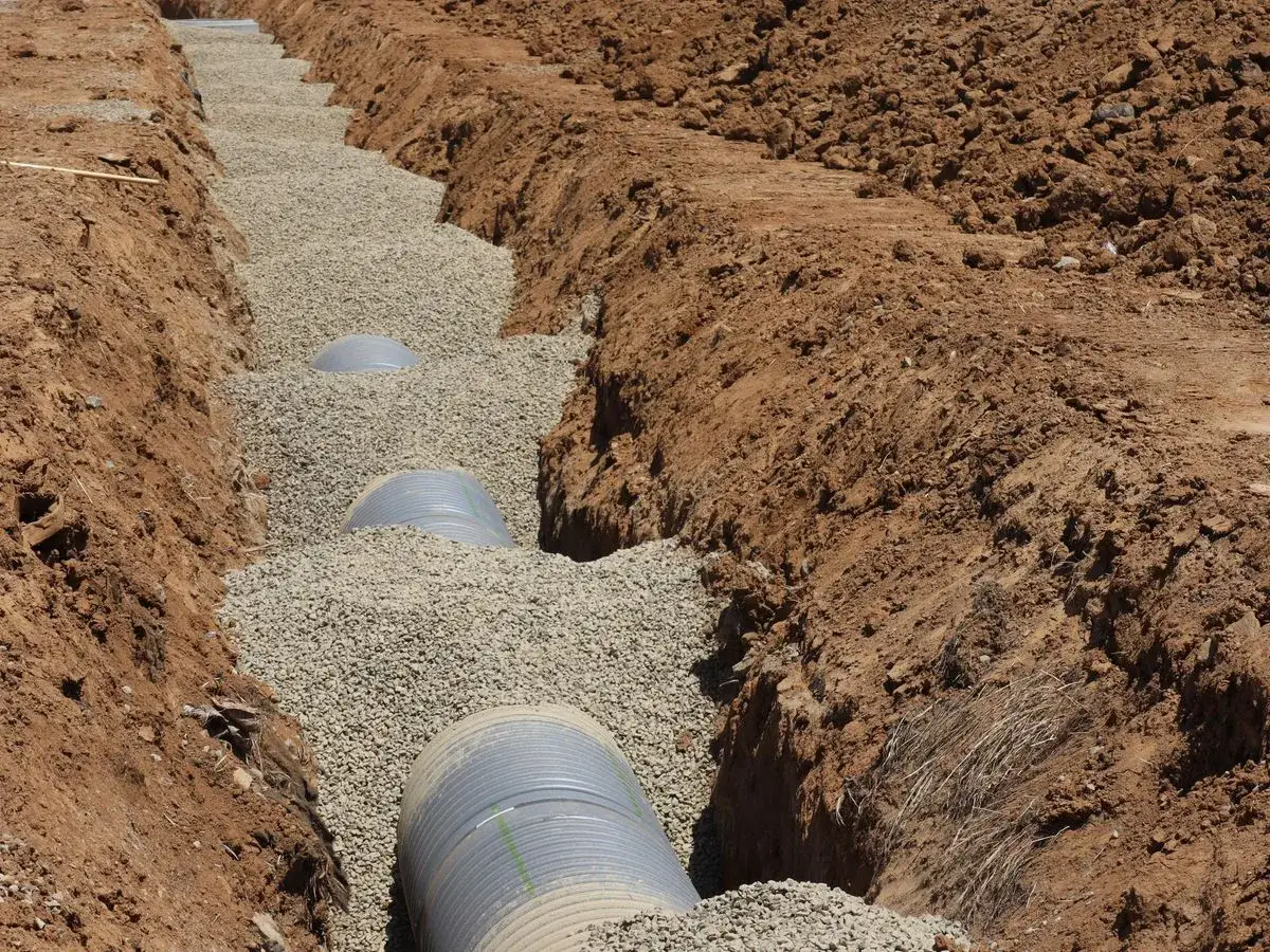 Sewer line being installed in an excavated residential trench in Rapid City, SD